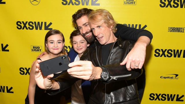 Michael Bay taking a selfie with John Krasinski, Noah Jupe, and Millicent Simmonds.