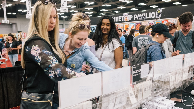 Marketplace attendees browse a local Austin boutique booth