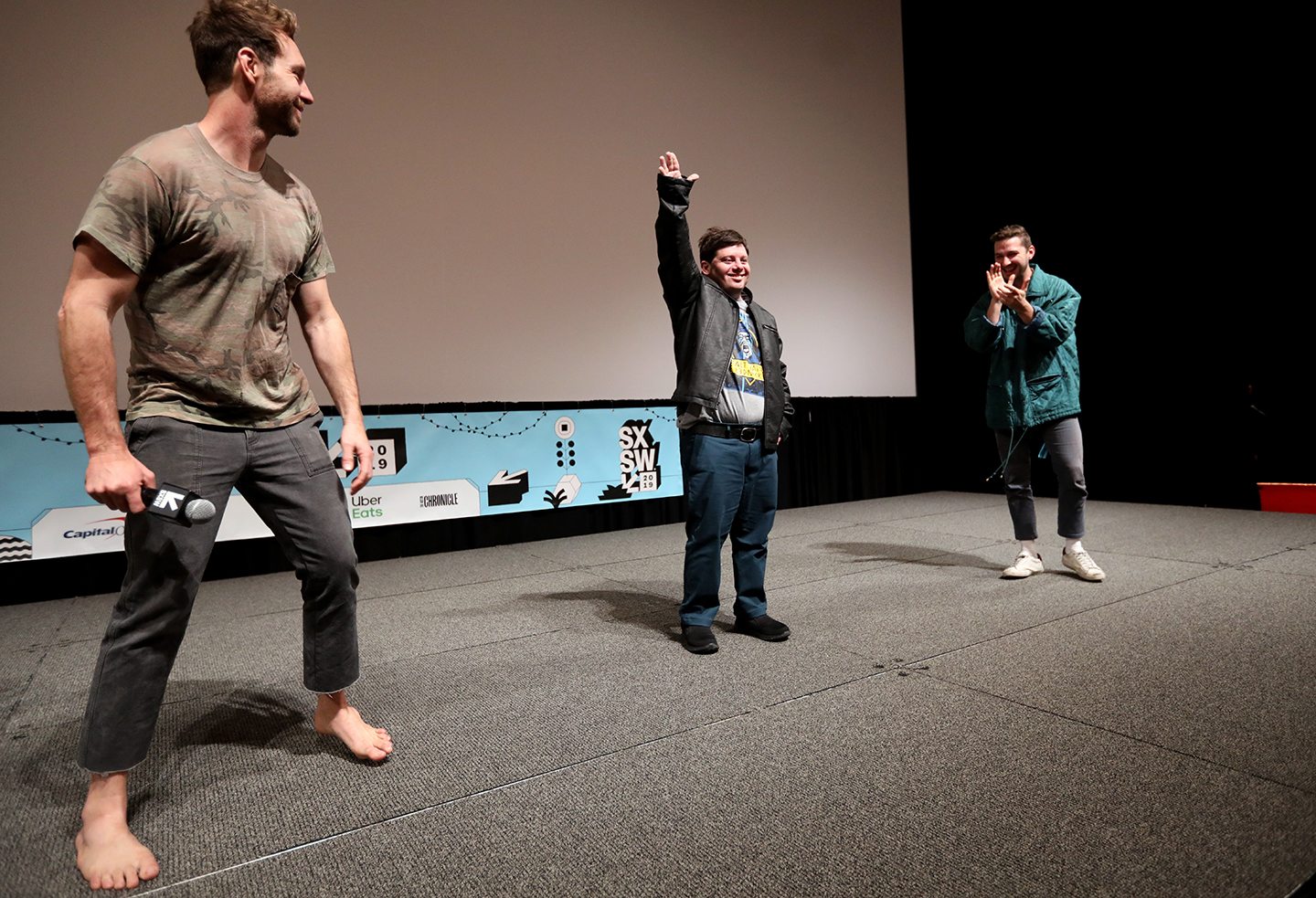 (L-R) Tyler Nilson, Zack Gottsagen, and Shia LaBeouf speak onstage at The Peanut Butter Falcon Premiere at the Atom Theater.