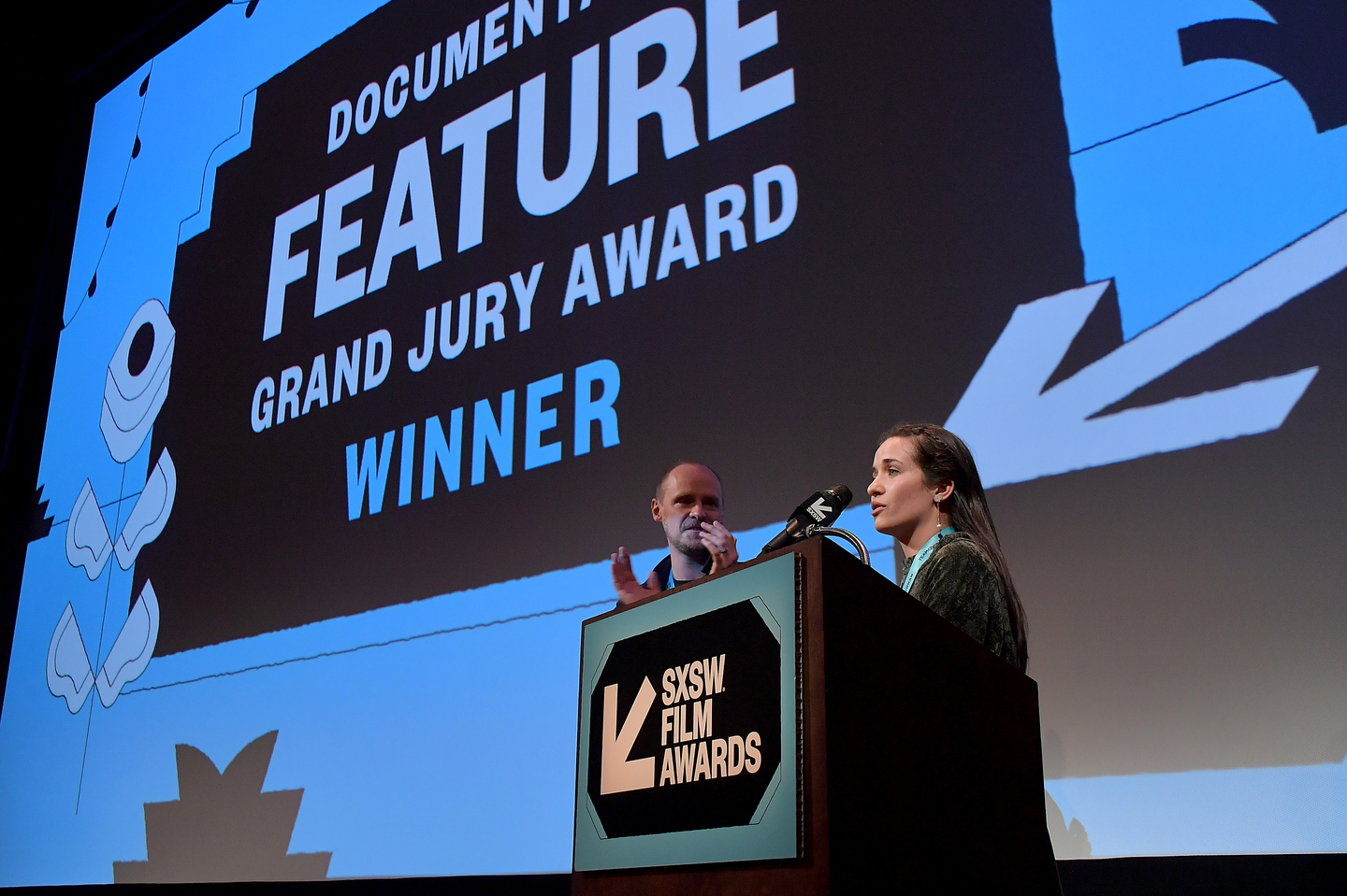 Edward Watts and Waad al-Kateab accept the Documentary Feature Grand Jury Award for their film For Sama at the SXSW Film Awards at the Paramount Theatre.